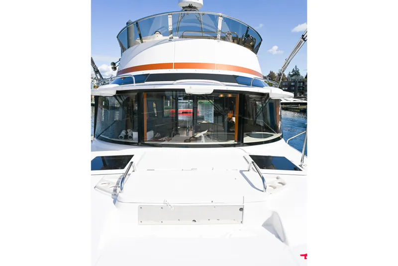 Slide: The Image of 2022 Ranger Tugs R-43 CB yacht, front view, docked in a marina. - 11