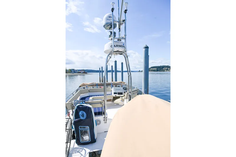 Slide: The Image of 2022 Ranger Tugs R-43 CB boat on calm water with clear sky. - 13