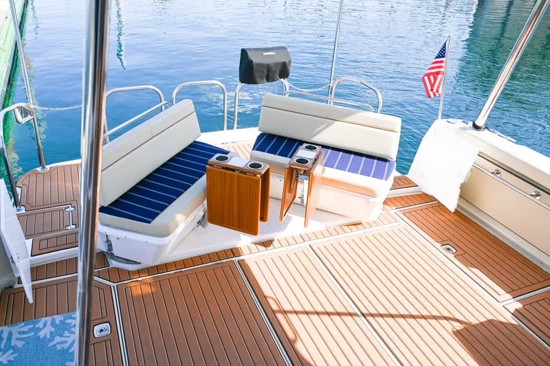 Slide: The Image of 2022 Ranger Tugs R-43 CB boat deck with seating and American flag. - 18