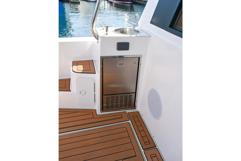 Slide: The Image of 2022 Ranger Tugs R-43 CB boat deck with sink and mini fridge. - 20