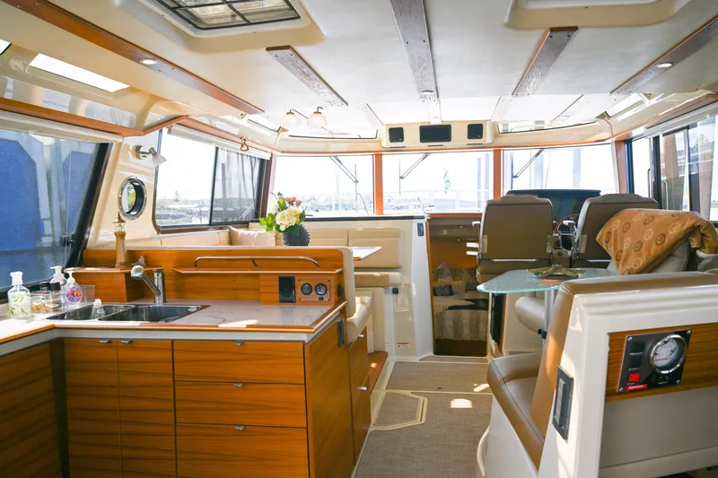 Slide: The Image of Interior of 2022 Ranger Tugs R-43 CB yacht with modern kitchen and seating area. - 26