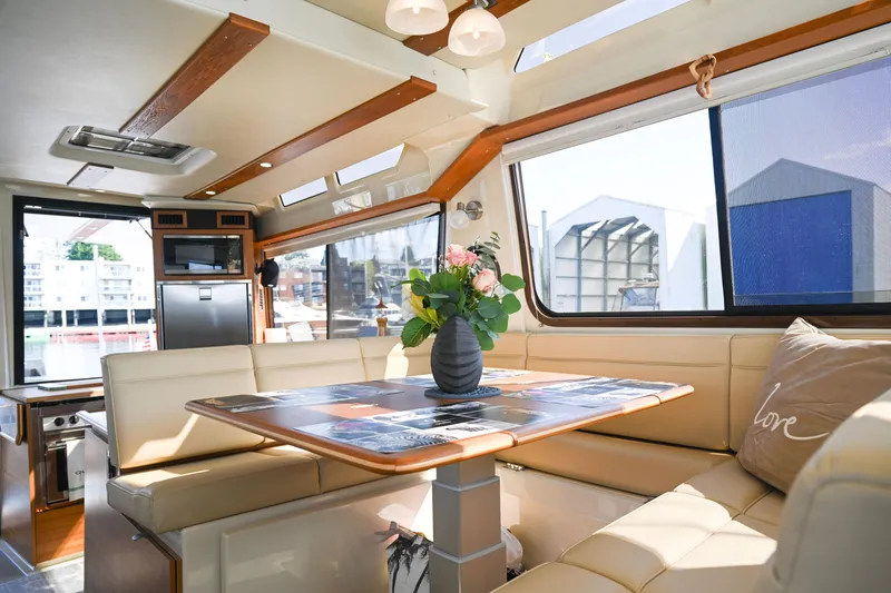 Slide: The Image of Interior of 2022 Ranger Tugs R-43 CB yacht with elegant dining area and floral centerpiece. - 28