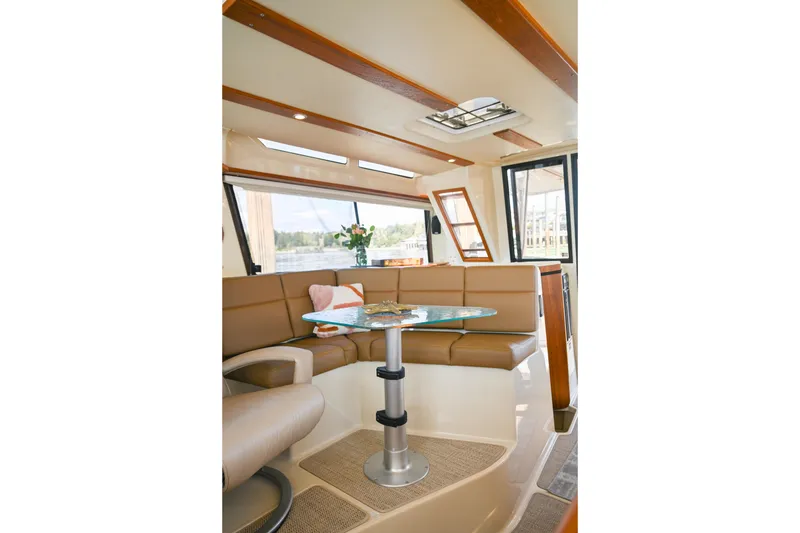 Slide: The Image of Interior of 2022 Ranger Tugs R-43 CB with modern seating and glass table. - 29