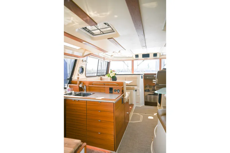 Slide: The Image of Interior of 2022 Ranger Tugs R-43 CB yacht, featuring a modern kitchen and seating area. - 30