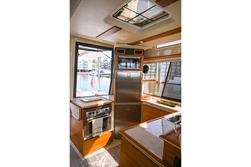Slide: The Image of Interior of 2022 Ranger Tugs R-43 CB yacht with modern kitchen and waterfront view. - 31