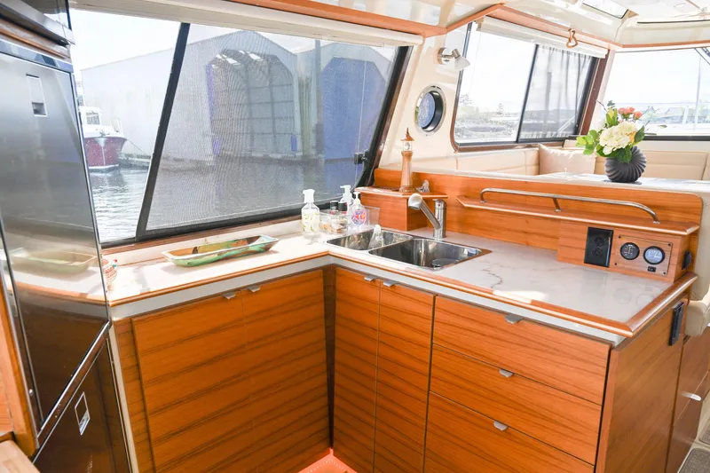 Slide: The Image of Luxurious 2022 Ranger Tugs R-43 CB yacht interior with modern kitchen and elegant wood finish. - 32