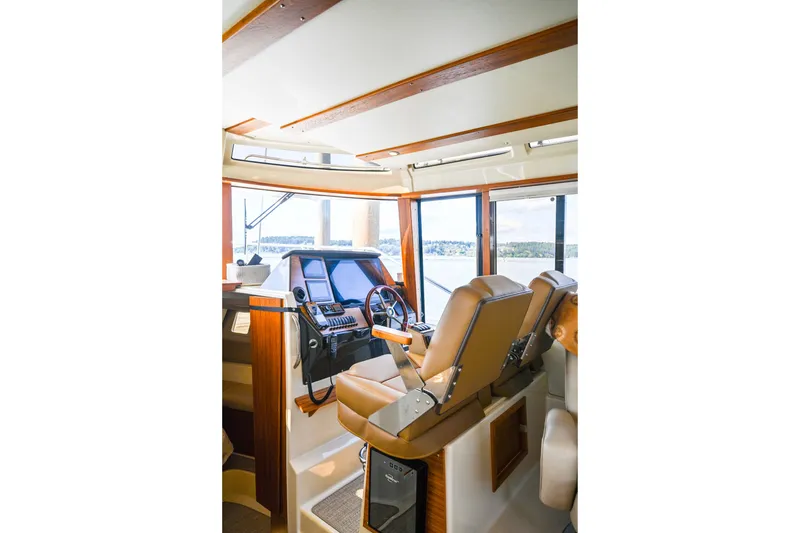Slide: The Image of Interior of 2022 Ranger Tugs R-43 CB boat with helm and seating area. - 35