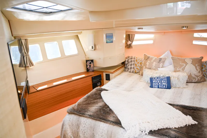 Slide: The Image of Luxurious 2022 Ranger Tugs R-43 CB cabin interior with cozy bedding and decorative pillows. - 44