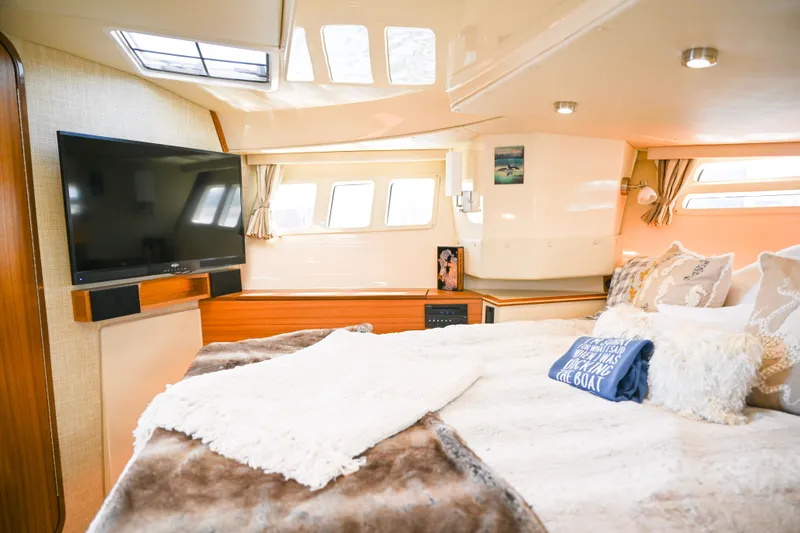 Slide: The Image of Luxurious interior of 2022 Ranger Tugs R-43 CB with cozy bedding and modern amenities. - 45