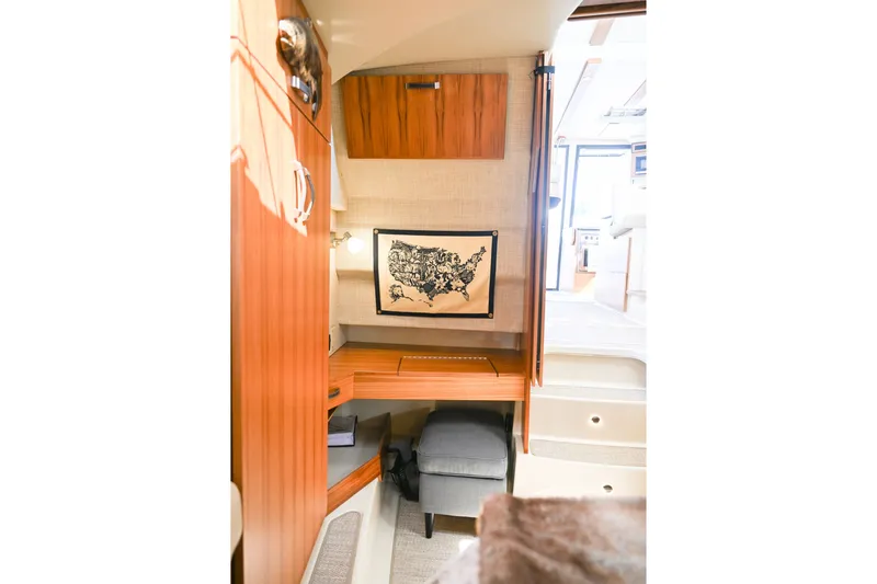 Slide: The Image of 2022 Ranger Tugs R-43 CB interior with wooden cabinetry and map decor. - 46