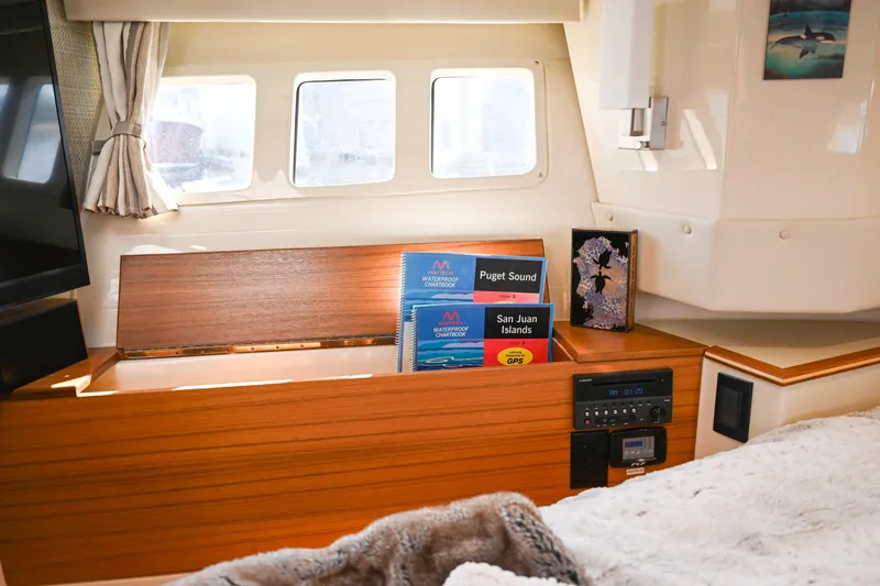 Slide: The Image of Interior of 2022 Ranger Tugs R-43 CB with navigation charts and cozy decor. - 47