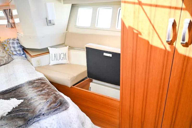 Slide: The Image of Interior of 2022 Ranger Tugs R-43 CB with cozy seating and decorative pillow. - 48