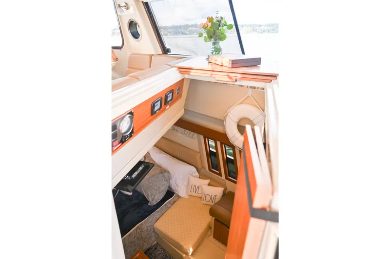 Slide: The Image of Interior of 2022 Ranger Tugs R-43 CB, featuring cozy cabin with decorative pillows. - 50