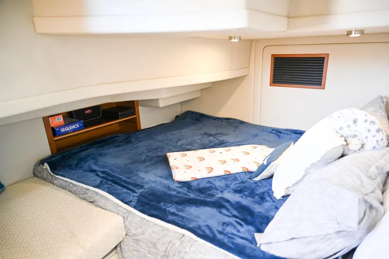 Slide: The Image of Cozy cabin interior of 2022 Ranger Tugs R-43 CB with plush bedding and storage. - 51