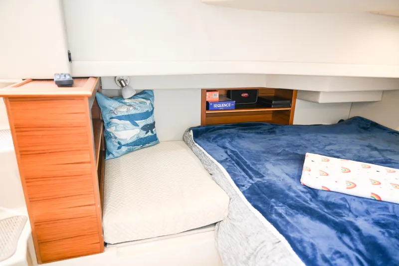 Slide: The Image of Cozy cabin interior of 2022 Ranger Tugs R-43 CB with plush bedding and decorative pillows. - 52