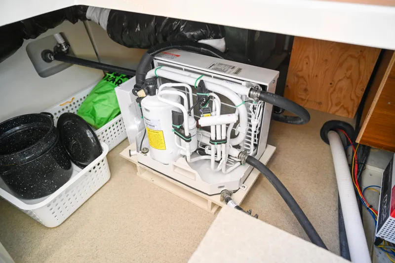 Slide: The Image of 2022 Ranger Tugs R-43 CB engine compartment with equipment and storage baskets. - 61