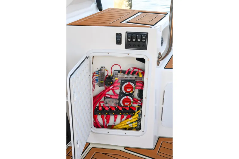 Slide: The Image of Electrical panel of 2022 Ranger Tugs R-43 CB with organized wiring and switches. - 62