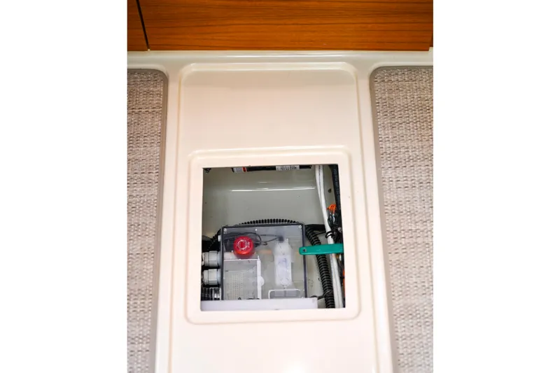 Slide: The Image of 2022 Ranger Tugs R-43 CB interior compartment with visible wiring and components. - 64