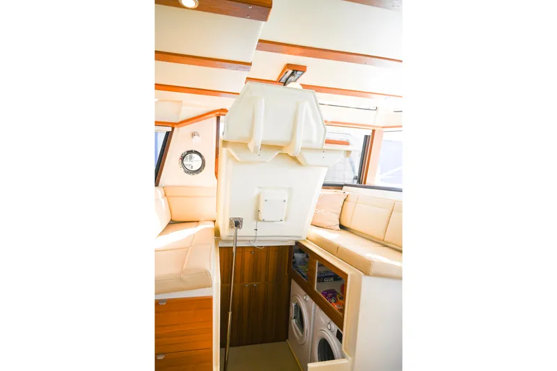Slide: The Image of Interior of 2022 Ranger Tugs R-43 CB with seating and laundry area. - 65