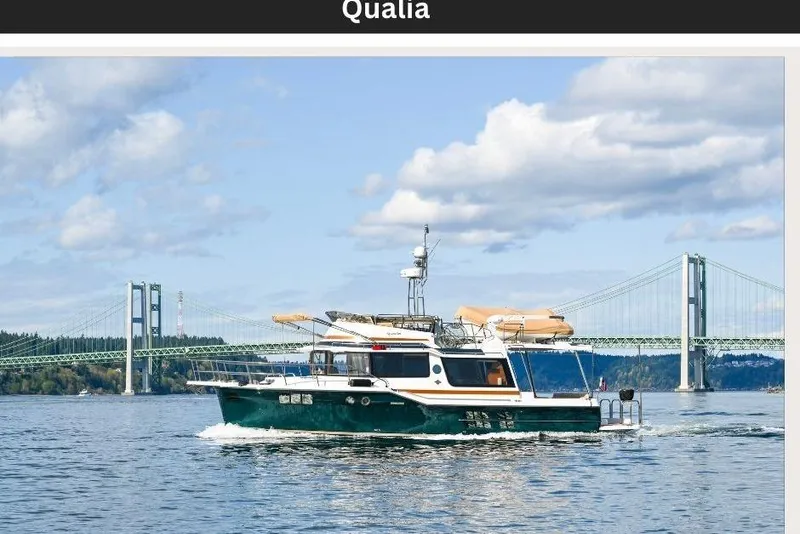 Slide: The Image of 2022 Ranger Tugs R-43 CB cruising near a scenic bridge under a partly cloudy sky. - 7