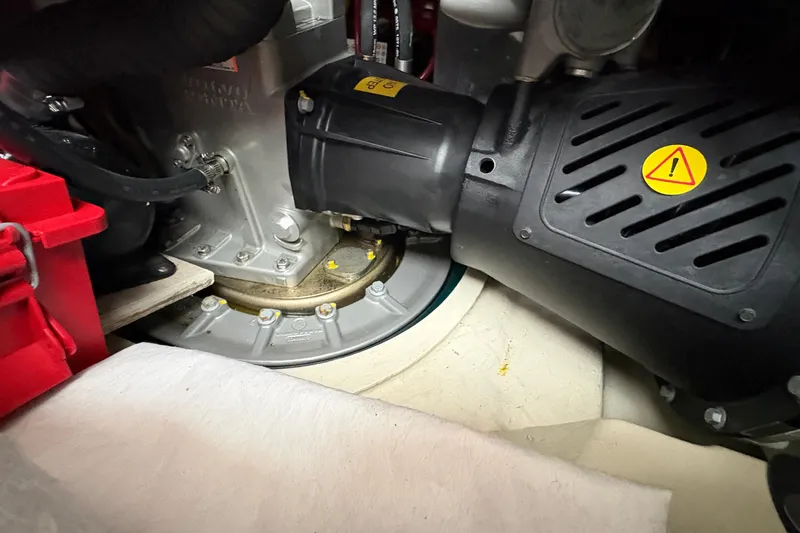 Slide: The Image of Engine compartment of 2022 Ranger Tugs R-43 CB, showcasing mechanical components and warning label. - 70