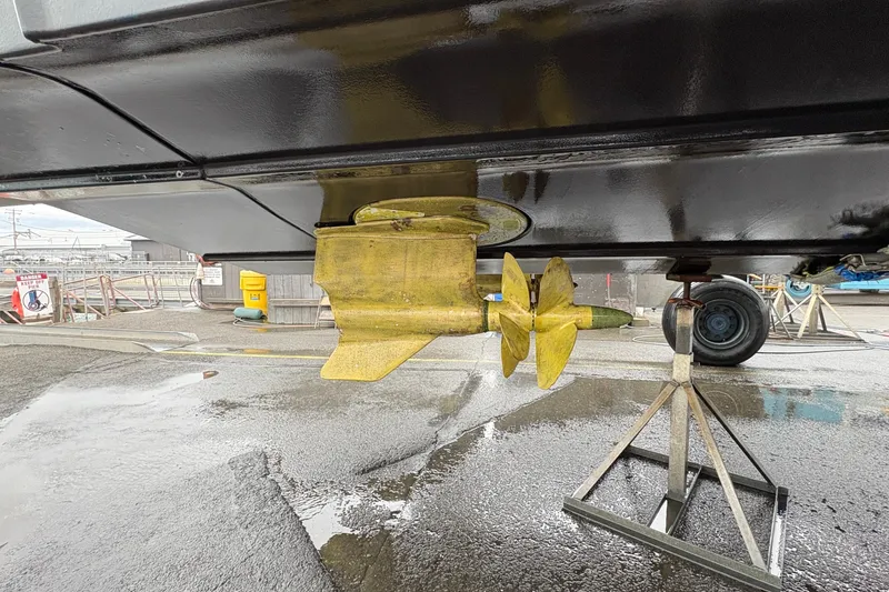 Slide: The Image of 2022 Ranger Tugs R-43 CB propeller and rudder detail in a boatyard setting. - 72