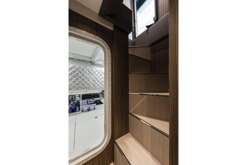 Slide: The Image of Interior stairs of 2026 Cranchi Settantotto 78 yacht, featuring sleek wooden design. - 29