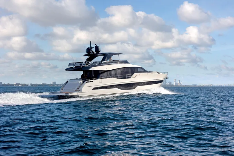 Slide: The Image of Luxury 2026 Cranchi Settantotto 78 yacht cruising on open water under a cloudy sky. - 47