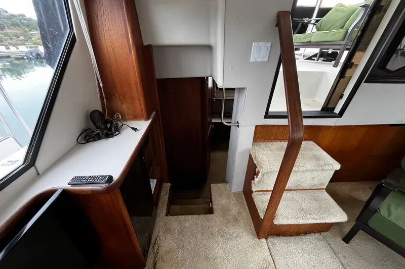 Slide: The Image of Interior of 1991 Carver 33 Aft Cabin Motor Yacht with stairs and seating area. - 17