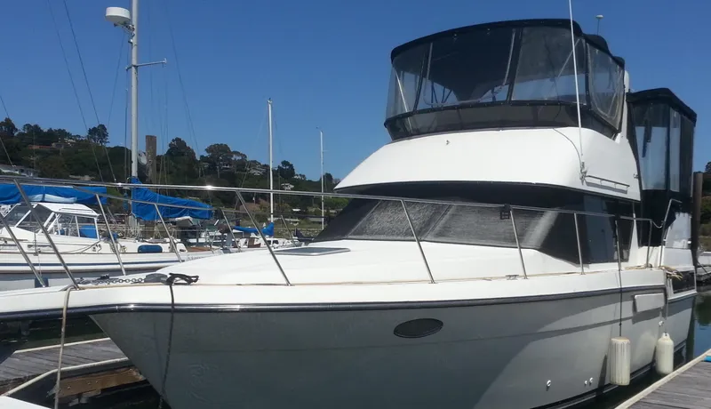 Slide: The Image of 1991 Carver 33 Aft Cabin Motor Yacht docked at marina. - 2