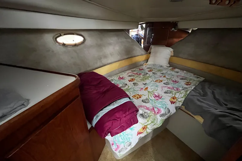 Slide: The Image of Cozy cabin interior of 1991 Carver 33 Aft Cabin Motor Yacht with floral bedding. - 23