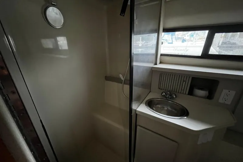 Slide: The Image of 1991 Carver 33 Aft Cabin Motor Yacht bathroom with shower and sink. - 34