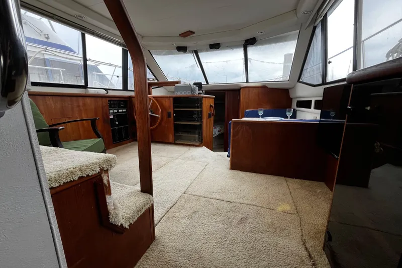Slide: The Image of Interior of 1991 Carver 33 Aft Cabin Motor Yacht with wood paneling and seating area. - 35