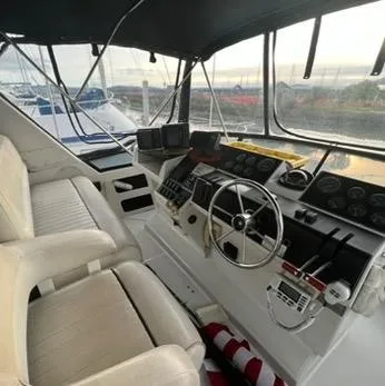 Slide: The Image of 1991 Carver 33 Aft Cabin Motor Yacht cockpit with steering wheel and navigation instruments. - 5