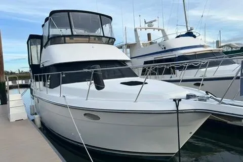 The Image of 1991 Carver 33 Aft Cabin Motor Yacht cruising on open water. - 0
