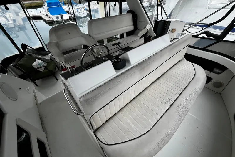 Slide: The Image of 1991 Carver 33 Aft Cabin Motor Yacht helm with dual seating and instrument panel. - 13