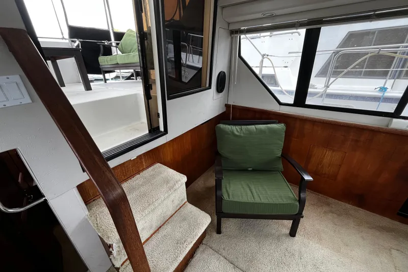 Slide: The Image of 1991 Carver 33 Aft Cabin Motor Yacht interior with helm and seating area. - 14