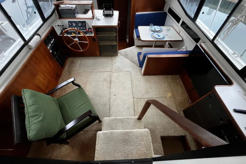 Slide: The Image of 1991 Carver 33 Aft Cabin Motor Yacht interior with green chair and carpeted stairs. - 15