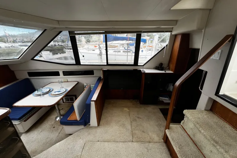 Slide: The Image of Interior of 1991 Carver 33 Aft Cabin Motor Yacht with helm, seating, and dining area. - 16
