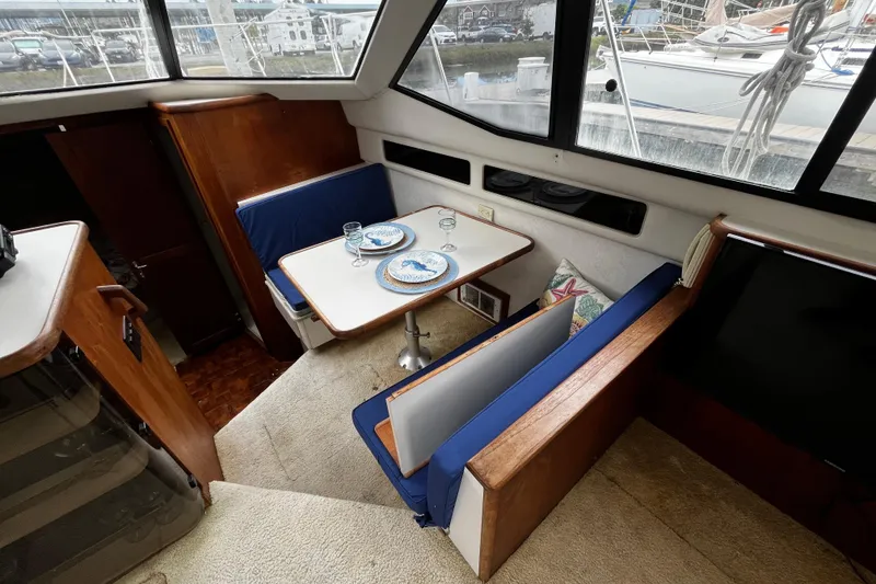 Slide: The Image of Interior of 1991 Carver 33 Aft Cabin Motor Yacht with stairs and seating area. - 18