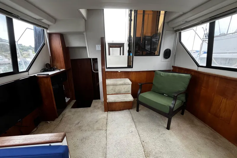 Slide: The Image of Cozy cabin interior of 1991 Carver 33 Aft Cabin Motor Yacht with floral bedding. - 24