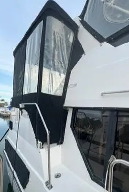 Slide: The Image of 1991 Carver 33 Aft Cabin Motor Yacht docked at marina. - 3