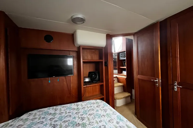 Slide: The Image of Cozy bedroom in 1991 Carver 33 Aft Cabin Motor Yacht with floral bedding. - 32