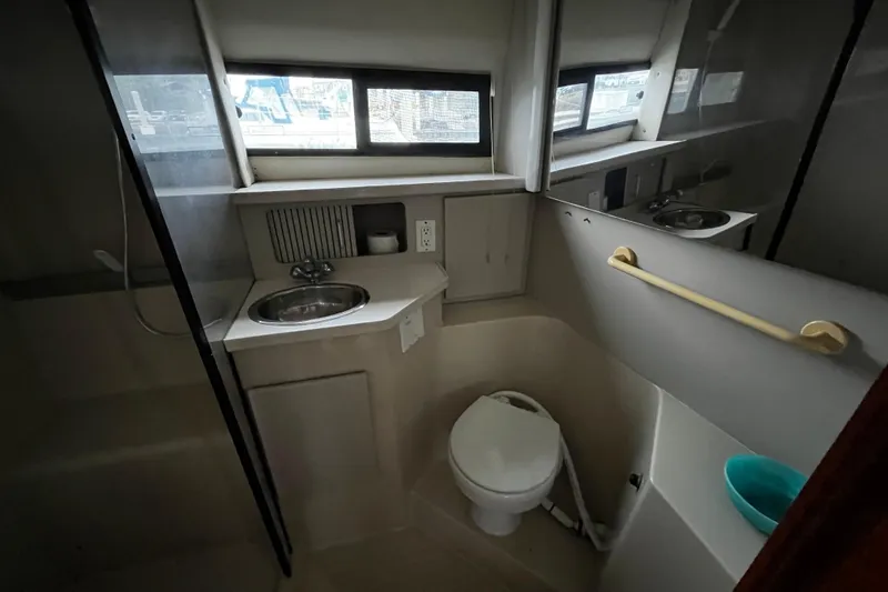 Slide: The Image of Interior of 1991 Carver 33 Aft Cabin Motor Yacht with wood paneling and TV. - 33