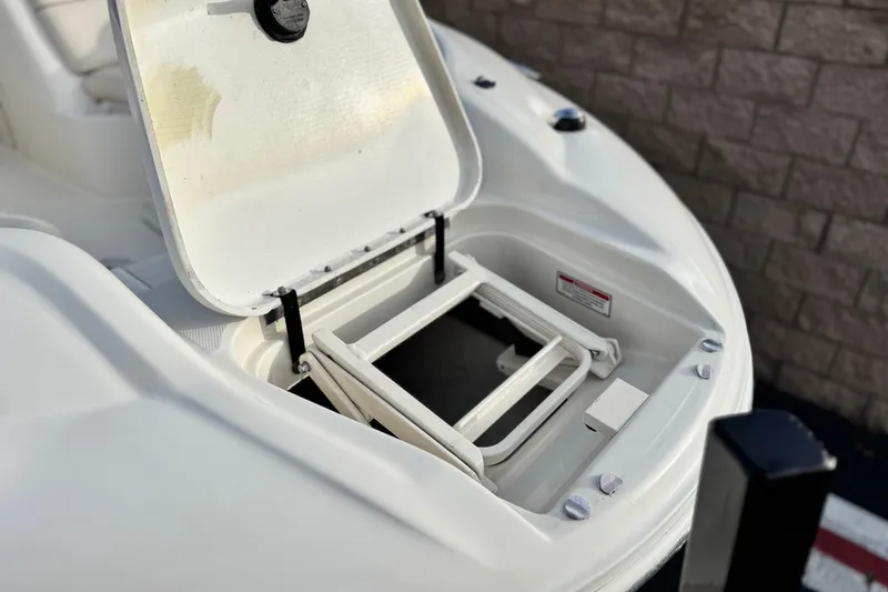 Slide: The Image of Open hatch on 2001 Sea Ray 240 Sundeck boat, revealing storage compartment. - 10
