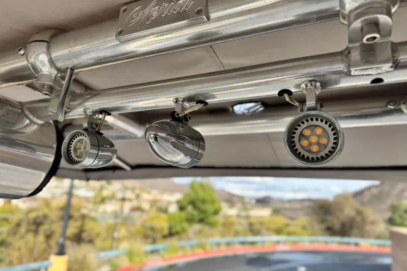 Slide: The Image of LED lights on a 2001 Sea Ray 240 Sundeck boat's metal frame. - 15