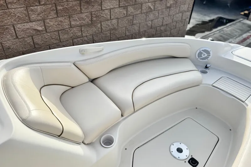 Slide: The Image of 2001 Sea Ray 240 Sundeck interior with cream leather seating and speaker. - 17