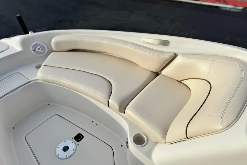 Slide: The Image of Cream leather seating on 2001 Sea Ray 240 Sundeck boat, featuring cup holder and speaker. - 18