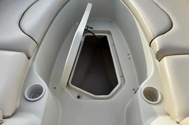 Slide: The Image of Interior view of a 2001 Sea Ray 240 Sundeck boat with open storage compartment. - 19