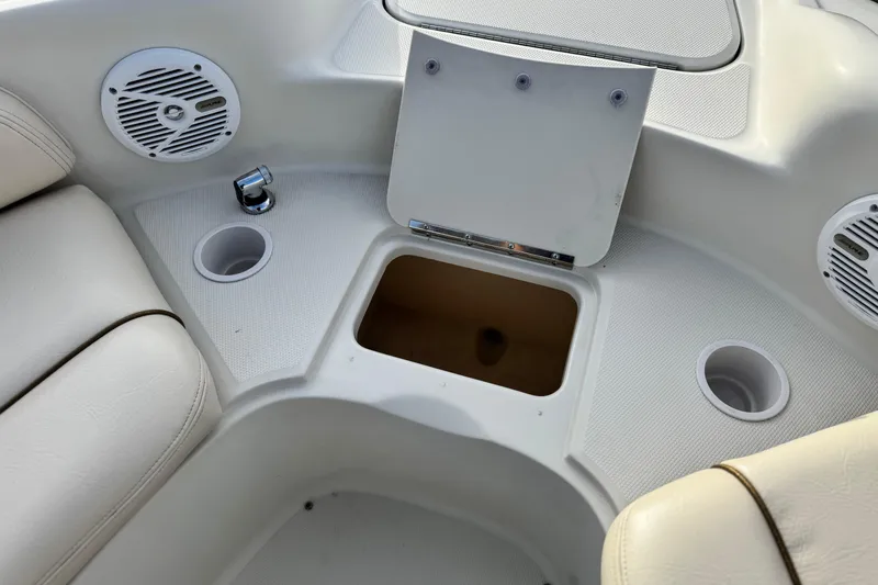 Slide: The Image of 2001 Sea Ray 240 Sundeck interior with cup holders and storage compartment. - 20